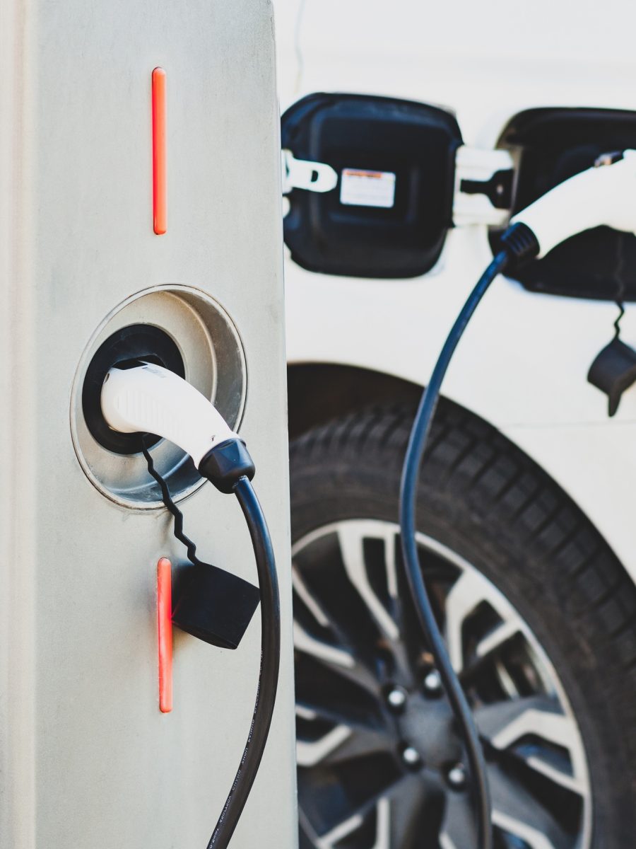 The electric car charger plugged in to the socket.The modern electric car charging the battery.